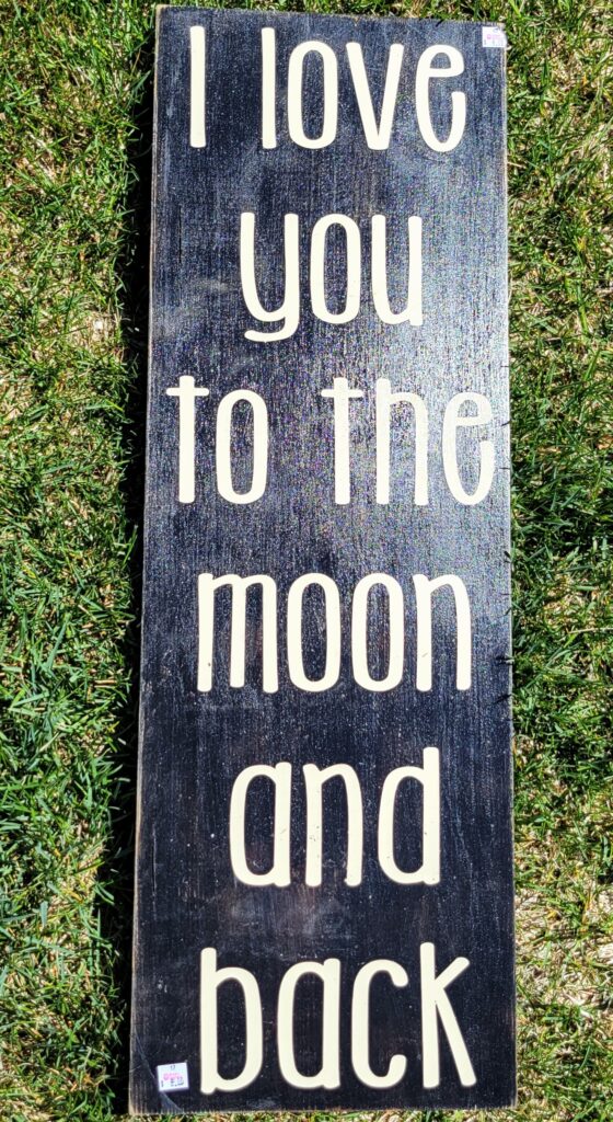 Love you to the moon and back quote on wood painted black
