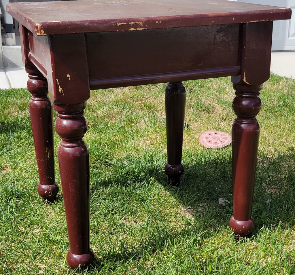 Old Thrifted Brown side table on grass