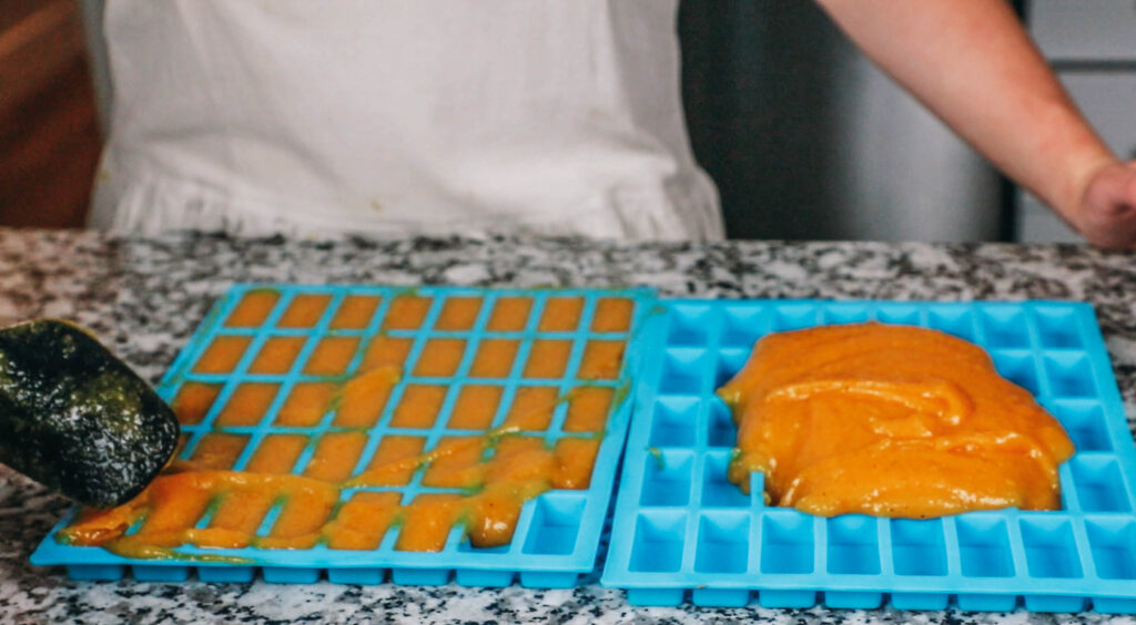 Pouring Fruit Puree into silicone molds