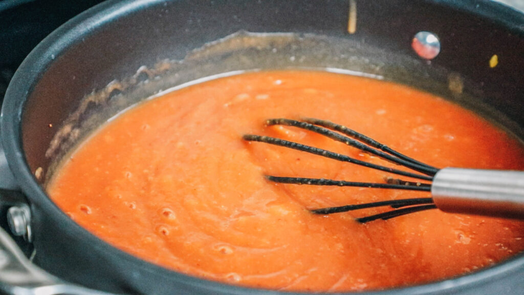 Whisk in fruit puree in pot