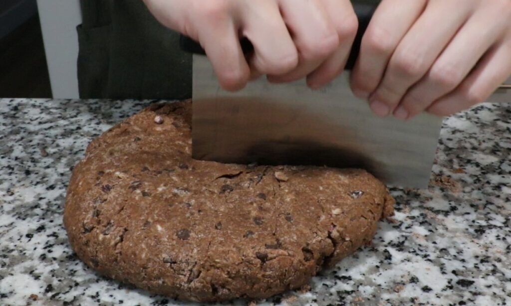 Chocolate Cherry Scone dough in metal bowl. Cutting with bench scraper