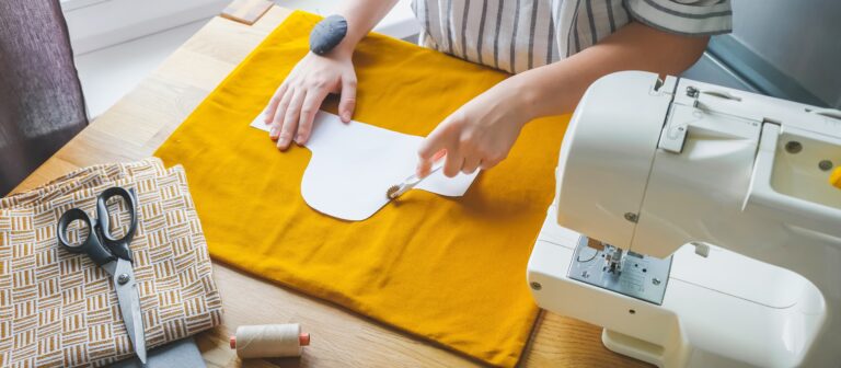 Cutting yellow fabric with sewing machine on the side