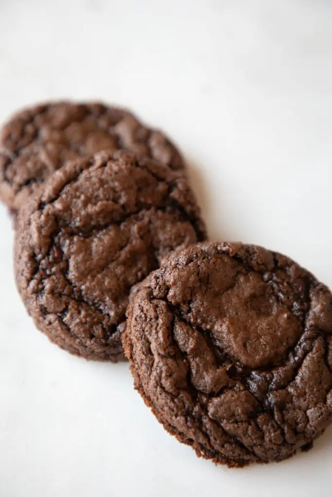 three chocolate cherry cookies on marble