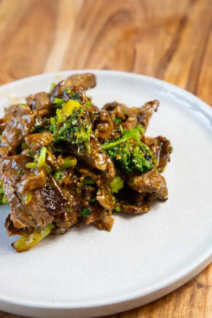 Beef and Broccoli on a grey plate on a wooden surface