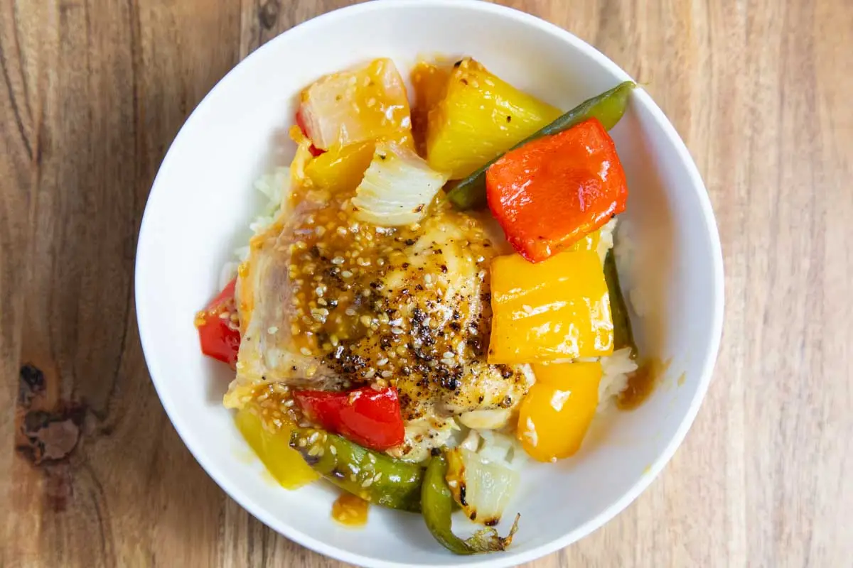 Hawaiian Teriyaki chicken in a white bowl on a wooden board