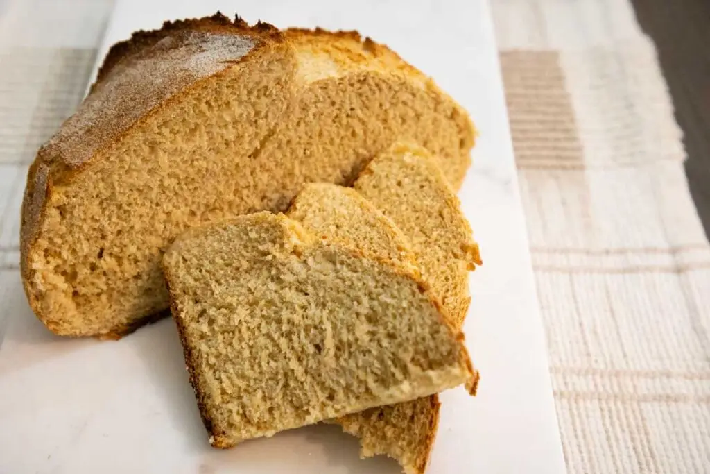 Freshly Milled flour loaf cut in pieces on wood